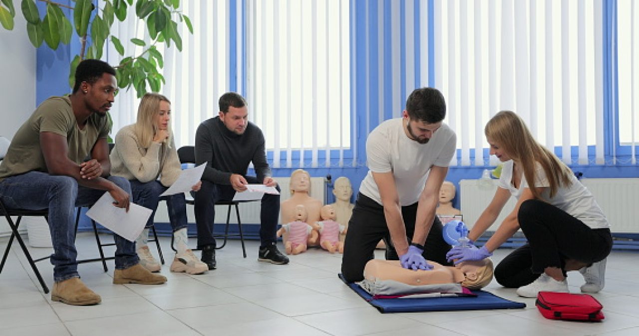 Male instructor teaching first Aid Cpr technique to his students